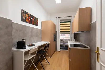 a kitchen with a counter and chairs in a room at Lifestyle Vatican Apartment in Rome