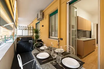 a dining room with a table and a kitchen at Lifestyle Vatican Apartment in Rome
