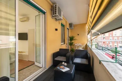a balcony of a building with chairs and a table at Lifestyle Vatican Apartment in Rome