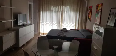 a living room with two chairs and a table with a view at Green Oasis in Rome