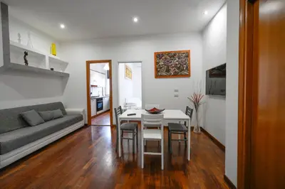 a living room with a table and a couch at Casa Angelico in Rome