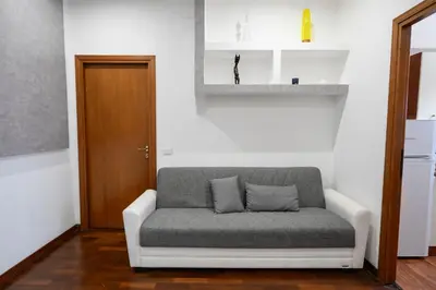 a couch sitting in a room with a door at Casa Angelico in Rome