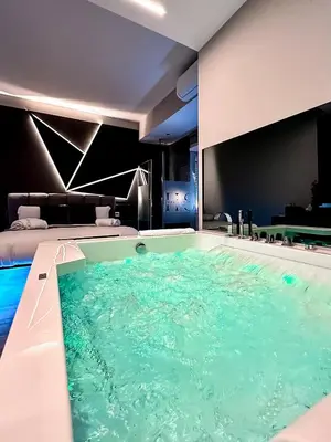 a large swimming pool in a hotel room at HeySuite - Luxury House - ROMA Trastevere in Rome