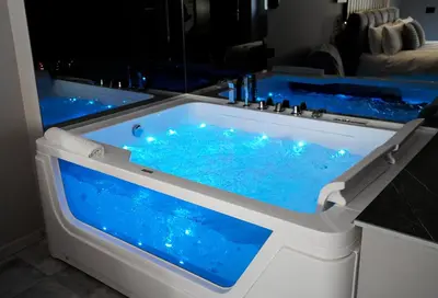 a hot tub with blue water in a room at HeySuite - Luxury House - ROMA Trastevere in Rome