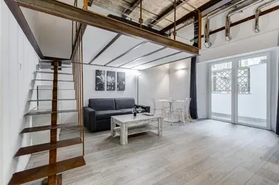 a living room with a couch and a table at Inner House 3 in Rome
