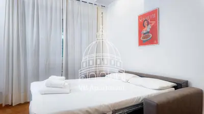 a bedroom with a large bed and a window at Vatican-Balduina Apartment in Rome