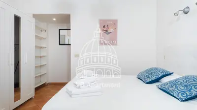 a bedroom with a white bed with a picture of the capitol at Vatican-Balduina Apartment in Rome