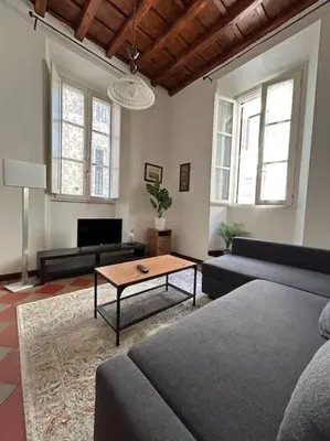a living room with a couch and a coffee table at Historic Apartment Via dei Coronari, Piazza Navona in Rome