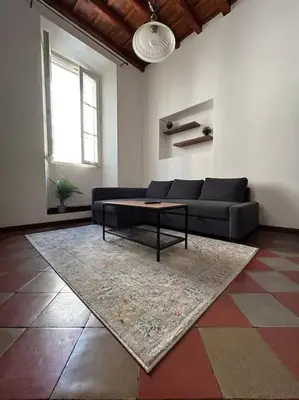 a bedroom with a bed with red pillows on it at Historic Apartment Via dei Coronari, Piazza Navona in Rome