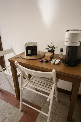 a table with a coffee maker and a coffeemaker on it at Historic Apartment Via dei Coronari, Piazza Navona in Rome
