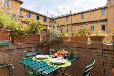 a table with plates of food on a patio at Rome as you feel - Luxury Cappellari Apartment in Rome