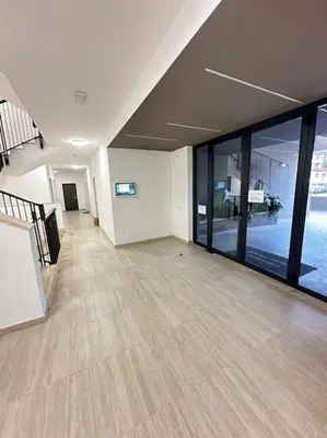 an empty room with large windows and a large floor to ceiling windowspect at Mini appartamento vicino Trastevere in Rome