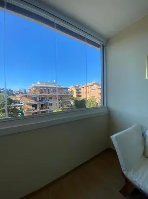 a room with a large window with a chair and a view at Mini appartamento vicino Trastevere in Rome