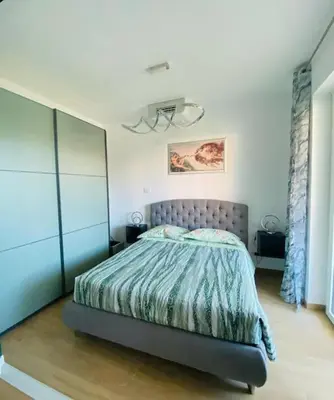 a bedroom with a bed with a blue comforter at Mini appartamento vicino Trastevere in Rome