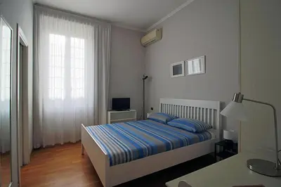 a bedroom with a bed and a desk and a window at Gelso in Rome