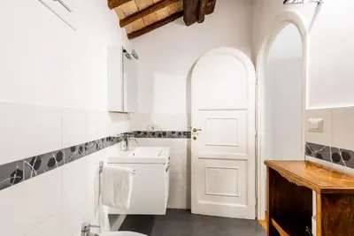 a white bathroom with a sink and a toilet at Pavone Centre Romantic Apartment in Rome