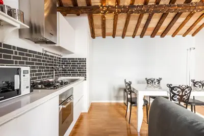 a kitchen with a table with chairs and a microwave at Pavone Centre Romantic Apartment in Rome