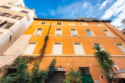 an orange building with plants in front of it at Pavone Centre Romantic Apartment in Rome