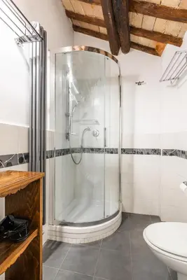 a glass shower in a bathroom with a sink at Pavone Centre Romantic Apartment in Rome