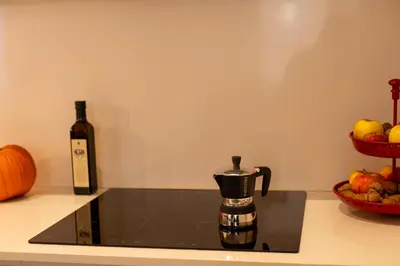a bottle of wine and a coffee maker on a counter at Banchi Nuovi, modern and cozy apartment in Rome