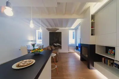 a kitchen and living room with a black counter top at Banchi Nuovi, modern and cozy apartment in Rome
