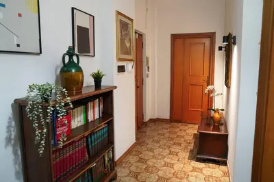 a hallway with a book shelf with books and a door at Da Bricca a Monteverde in Rome