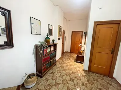 a hallway with a book shelf with books and a door at Da Bricca a Monteverde in Rome