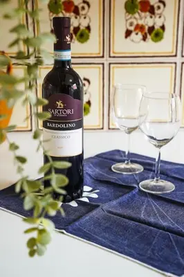 a bottle of wine sitting on a table with two glasses at Da Bricca a Monteverde in Rome