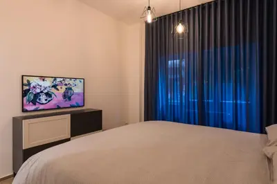 a bedroom with a bed and a flat screen tv at Super Comfort Pisino Street in Rome