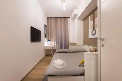 a small room with a bed and a desk at Super Comfort Pisino Street in Rome