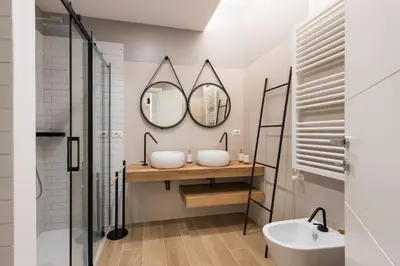 a bathroom with two sinks and a mirror at Super Comfort Pisino Street in Rome