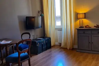 a living room with a table and a tv on a wall at CAMERA con VISTA in Rome