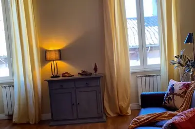 a lamp on a cabinet in a room with windows at CAMERA con VISTA in Rome