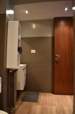 a room with a door and a room with a wooden floor at CAMERA con VISTA in Rome