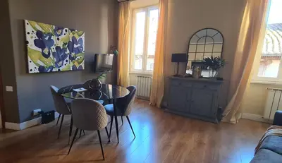 a living room with a glass table and chairs at CAMERA con VISTA in Rome