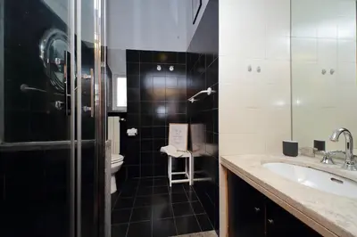 a black and white bathroom with a sink and a toilet at Metastasio in Rome