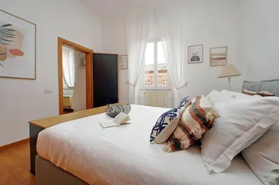 a bedroom with a large white bed with pillows at Metastasio in Rome