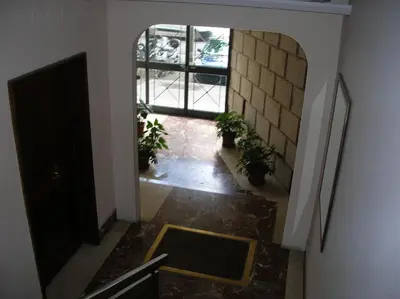 an empty hallway with plants and a window at Chiara Stella Guest House in Rome