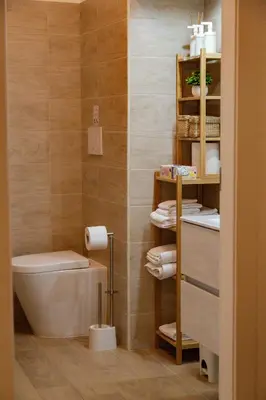 a bathroom with a toilet and towels on a shelf at Angelina's cozy home in Rome