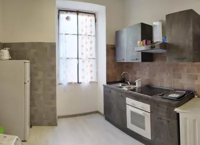 a kitchen with a sink and a refrigerator and a window at Rome Near Colosseum in Rome