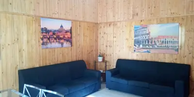 two blue couches in a room with wooden walls at Rome Near Colosseum in Rome
