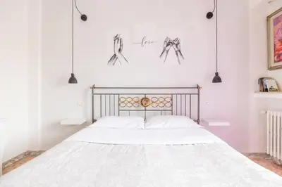 a bedroom with a bed with spider drawings on the wall at Ambra's bright apartment in Rome