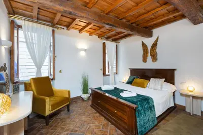 a bedroom with a bed and a desk and a chair at TimeRoma Suites in Rome