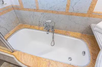 a bath tub in a bathroom with a shower at TimeRoma Suites in Rome