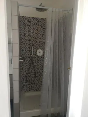 a shower with a shower curtain in a bathroom at La Terrazza di Attila in Rome