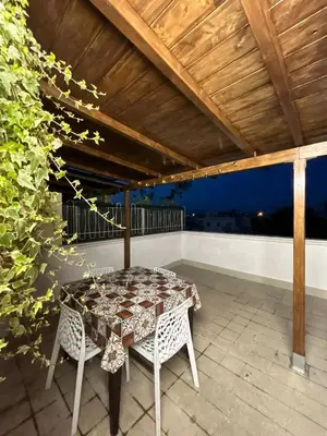 a table and two chairs on a patio at La Terrazza di Attila in Rome