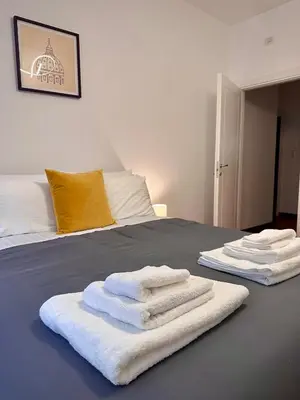 two towels are stacked on a bed in a room at Comodo appartamento a pochi passi dalla fermata Porta Metronia Metro C in Rome