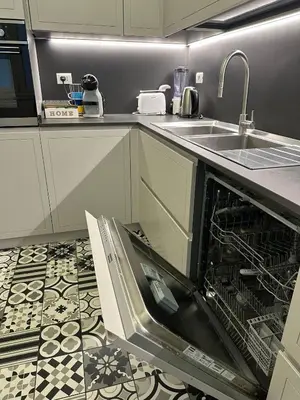 an oven with its door open in a kitchen at Comodo appartamento a pochi passi dalla fermata Porta Metronia Metro C in Rome