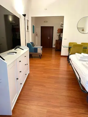 a room with two beds and a living room at Comodo appartamento a pochi passi dalla fermata Porta Metronia Metro C in Rome