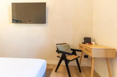 a bedroom with a desk and a chair next to a table at Cunabu Apartments in Rome